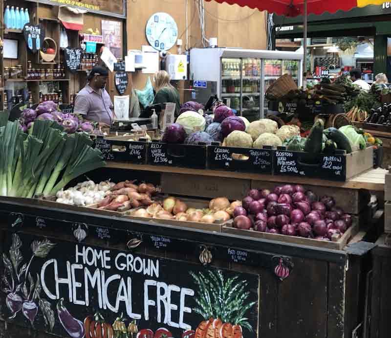 Home grown chemical free sign with display of vegetables.