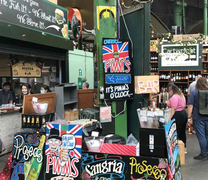 Colourful signs advertsing PImms, Prosecco & Sangria.