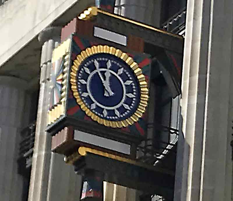 Clock Art Deco motifs in red, gold and blue.