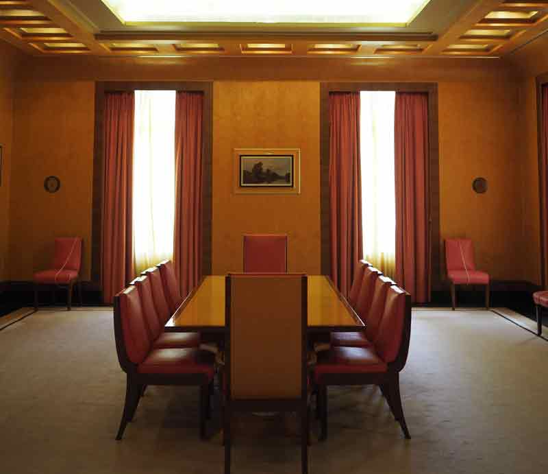 Eltham Palace dining room Art Deco style table, wood panelling and lighting.