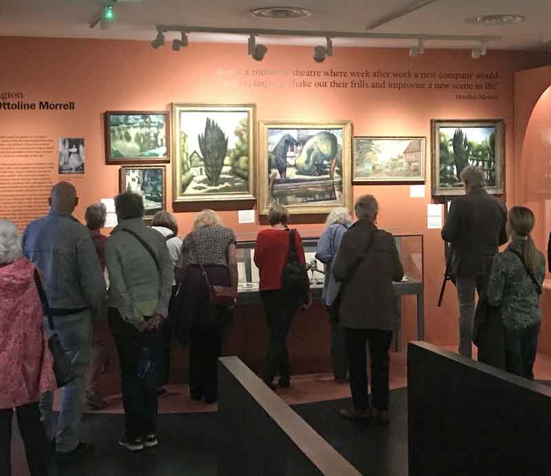 Garden Museum art exhibition Visitors viewing illuminated paintings.
