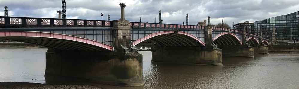 At Thames low tide from Millbank with dull grey skies..