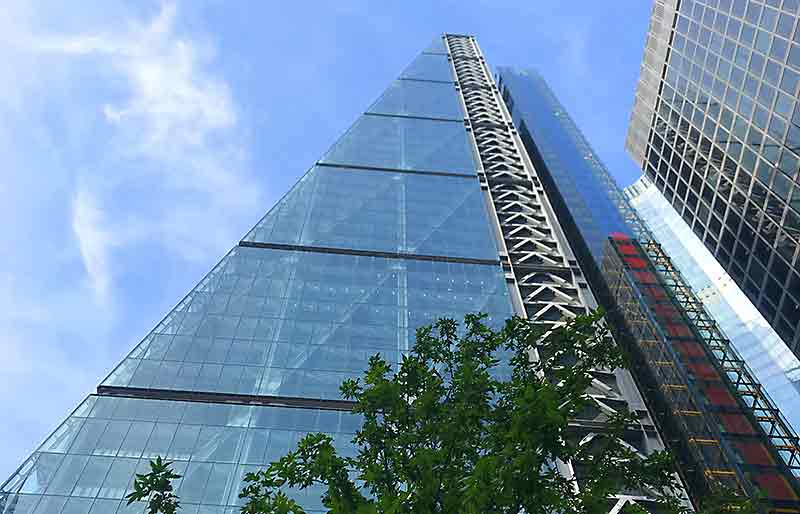The Cheesegrater skyscraper Towering glass-clad wedge-shaped exterior.