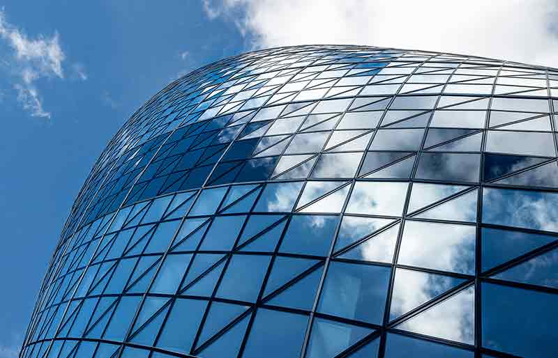 The Gherkin skyscraper Looking up at the triangular glass exterior sections.