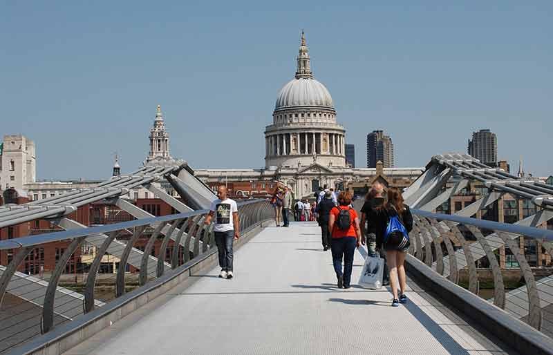 Millennium Bridge Pedestrians crossing towards St Paul's Cathedral in the distance.