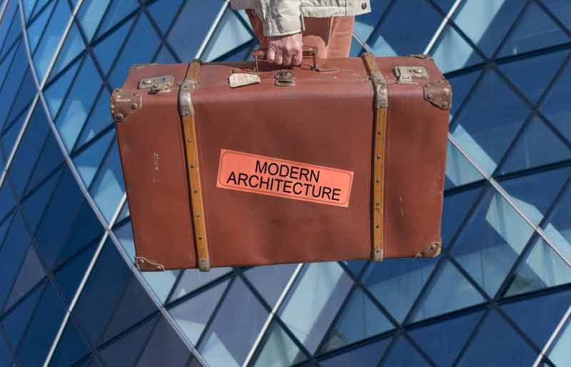 Modern Architecture Vintage brown leather suitcase with category travel label on Gherkin geometric windows background.