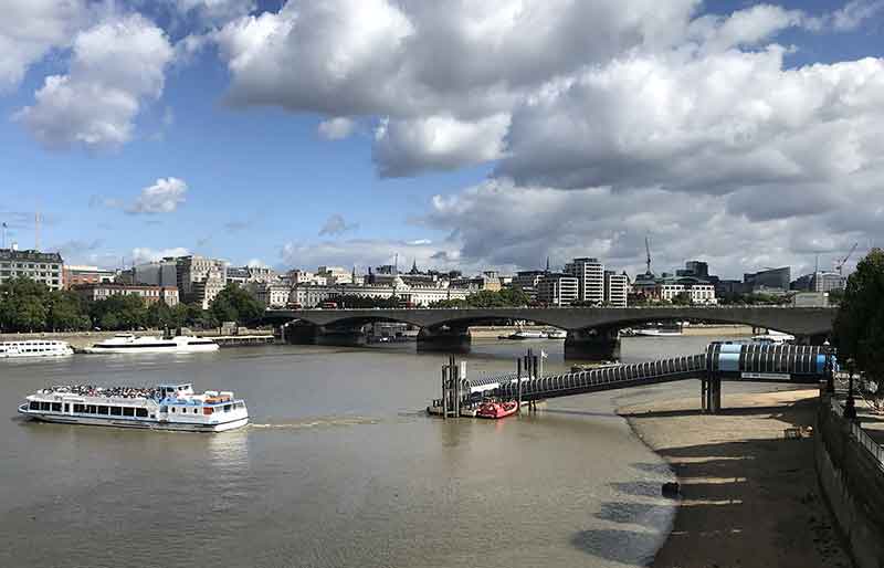 Waterloo Bridge View from Golden Jubilee Bridge with Thames Clipper leaving Festival Pier.