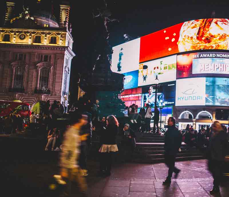 At night with illuminated advertising.