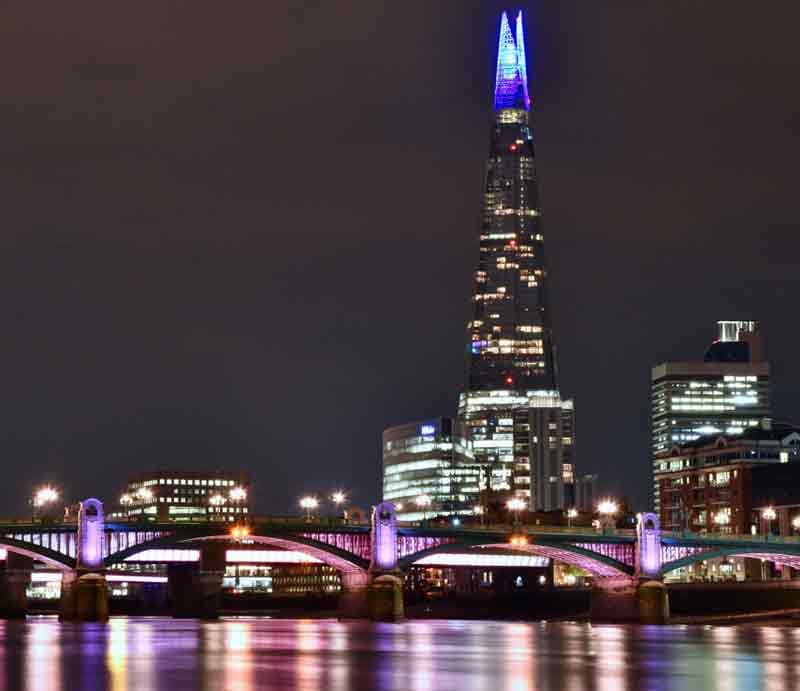 The Shard skyscraper Illuminated at night with neon blue upper section.